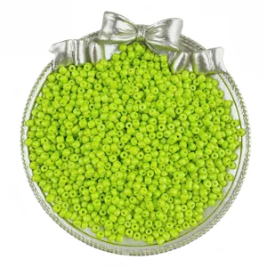 Green glass seed beads in silver bow dish for DIY handmade bracelet necklace jewelry accessories making.