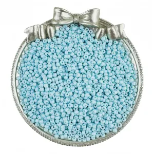 Detailed view of light blue seed beads in decorative silver bowl, perfect for DIY jewelry making.