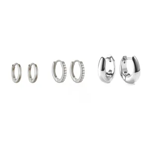 Detailed view of minimalist silver hoop earrings set, showcasing various sizes and polished finish.