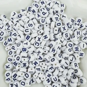 Detail view of acrylic letter beads with clear black alphabets for DIY bracelets.