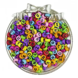 Close-up of colorful acrylic letter beads with black letters for DIY friendship bracelets.