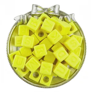 Yellow acrylic 12mm cube letter beads close-up, perfect for DIY handmade bracelets and jewelry.