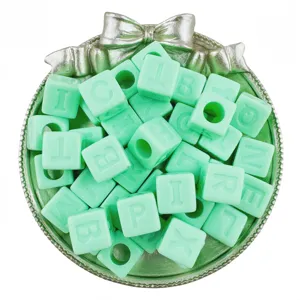 Detail shot of 12mm light green acrylic square letter beads for DIY jewelry making crafts.