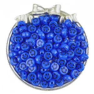 Close-up detail of blue acrylic smiley face loose beads with embossed expression for DIY jewelry.