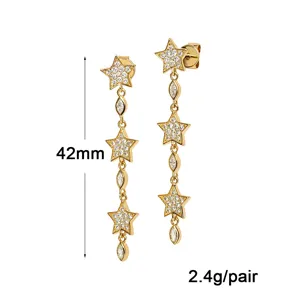 Vue détaillée de longues boucles d'oreilles étoiles avec zircons brillants dorés.