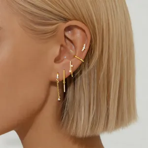 Detail shot of golden multi-piece ear cuff set, featuring delicate chain and rhinestone accents.