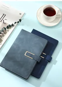 Macro view of A5 business notebook with faux leather texture and gold buckle detail