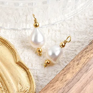 Close-up of baroque natural freshwater pearl pendant with gold metal pin for DIY jewelry making.