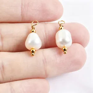 Closeup of irregular natural freshwater pearl pendants with gold-plated pins for DIY jewelry.