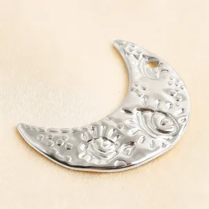 Silver moon pendant closeup, evil eye textured charm detail, DIY jewelry accessory part.