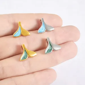 Close-up detail of stainless steel whale tail pendant with colorful enamel for DIY jewelry making.