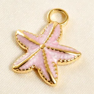 Gold plated pink enamel starfish pendant closeup, DIY handmade jewelry making accessory.