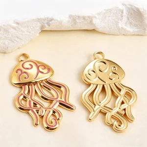 Detalle de colgantes de medusa huecos chapados en oro con esmalte rosa para joyería de bricolaje.
