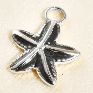 Close-up detail of silver starfish pendant with black enamel finish for DIY jewelry making.
