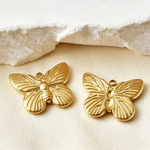 Close up shot of shiny gold butterfly charms, detailed wings, perfect for DIY jewelry making.