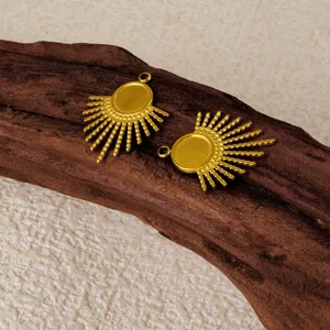 Gold sunburst pendant detail shot, stainless steel jewelry charm for DIY craft making.