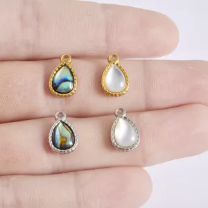 Close up of stainless steel teardrop shell pendant details, natural pearl DIY jewelry charms.