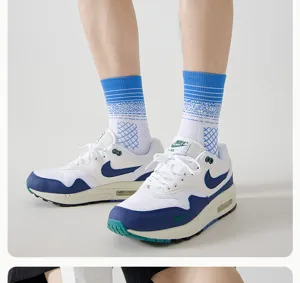 Men's mid-tube sports socks with blue-white gradient design, breathable mesh and cushioned towel bottom.