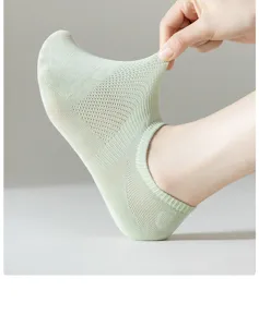Close-up view of light green mesh ankle socks, showing breathable fabric and stretchy fit detail.