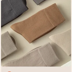 Close-up of cozy thickened mid-tube thermal winter socks in neutral colors, soft texture.