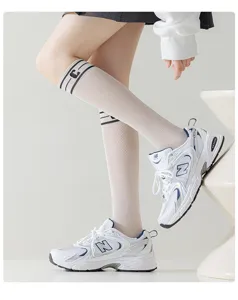 Summer thin mesh knee-high socks for women, breathable white long socks with stylish letter design.