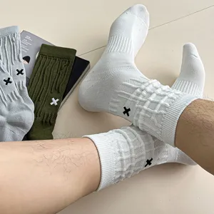 Men's solid color mid-tube cotton socks with waffle texture and stylish cross embroidery.