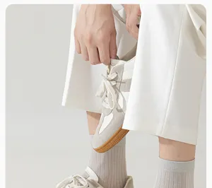 Men's breathable cotton mid-tube socks detail shot, casual socks footwear pairing display.