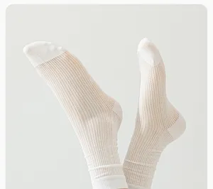 Detail view of breathable mesh slouch socks for women, soft summer white mid-tube hosiery.