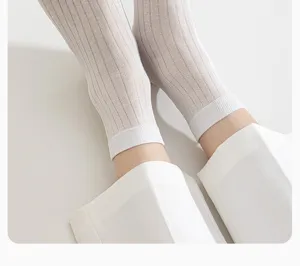 Close-up detail of men's summer thin breathable ribbed mid-tube socks in white design.