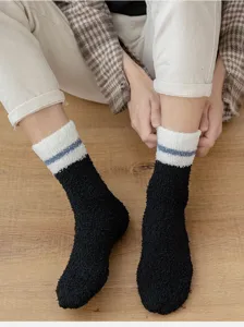Closeup detail shot of plush warm fleece fuzzy socks featuring black and cozy winter design.