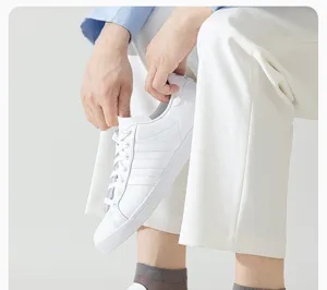Classic white low-top casual sneakers with iconic three-stripe design for daily comfort.