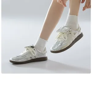 Silver metallic sneakers styled with cute white ruffled socks, detailed close-up shot.