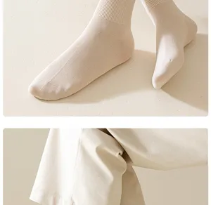 Detail shot of ribbed knit cotton mid tube socks in neutral beige tone, comfortable fit.