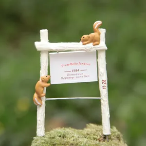 Detailed close-up of miniature resin squirrel fence sign, perfect for garden decoration.