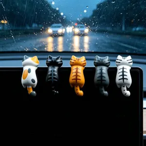 Primo piano di statuetta di gatto carino, ornamento decorativo sospeso per monitor auto.