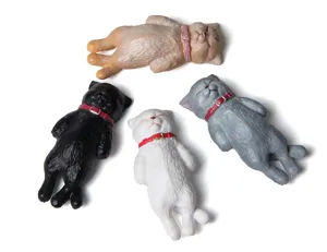 Close-up detail of cute sleeping cat figurines with collars, ideal for DIY keychains and charms.