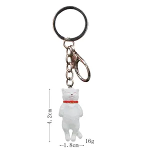 Detail view of the cute sleeping cat keychain with a white pendant and metal ring.