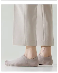 Close-up detail view showing breathable thin low-cut boat socks worn on foot.