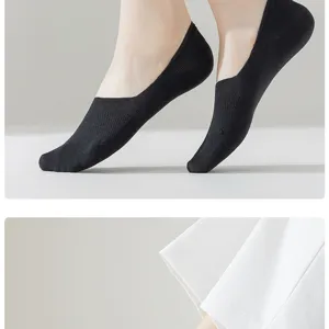 Close-up of black invisible boat socks for women, breathable mesh design, anti-slip fit.