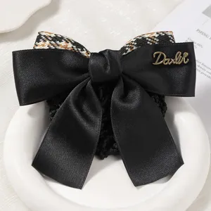 Elegant black satin hair net bow with houndstooth pattern detail and metal accent.