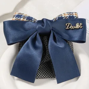 Detailed view of professional navy blue bow hair net with houndstooth pattern and mesh pocket.
