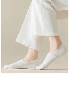 Detail view of womens shallow boat socks in white cotton breathable fabric for summer.