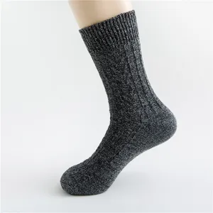 Close up of thick warm wool blend knit winter socks with retro cable pattern in dark grey.