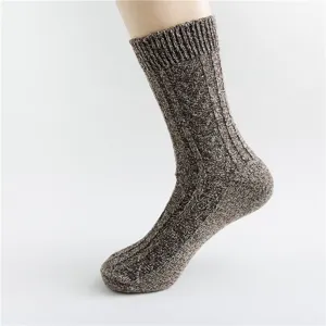 Close-up detail of thick thermal wool blend knit socks with vintage textured pattern.