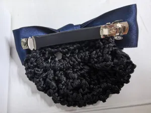 Detailed view of the blue satin hair bow with black net, professional bun cover hairpin.