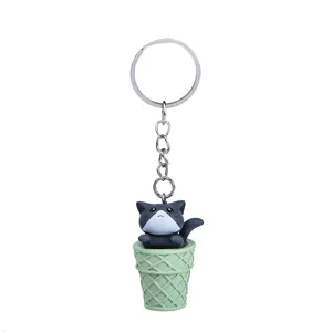 Close-up detail of the cute cat ice cream cone keychain, showing the fine resin texture and hardware.