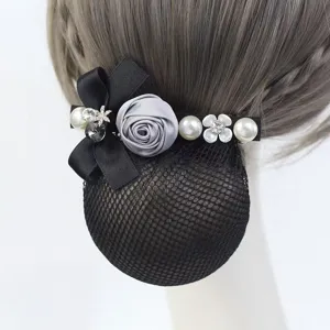 Detail shot of professional hair net bun cover with black bow and pearl decoration.