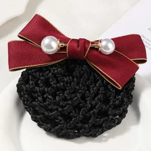 Close-up detail of elegant red bow hair net with pearls for women professional workplace style.