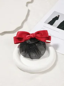 Close-up detail shot of professional hairnet featuring a classic red bow, elegant hair accessory.