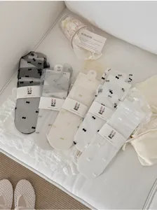 Details of sheer mesh bowknot crew socks, lightweight and breathable spring summer hosiery.